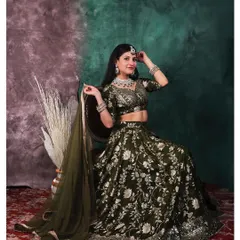 Elegance captured in a single frame. This portrait showcases a stunning traditional lehenga, where we used a painterly backdrop and soft lighting to highlight the intricate details of the fabric and jewelry.