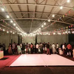 Our indoor event hall is a blank canvas for any party. Here it is set up for a corporate sangeet with a large dance floor, festive lighting, and a professional DJ setup.