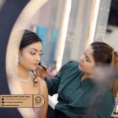 Another shot of the makeup application process, seen through a ring light. I take great care in ensuring every detail is perfect for your special occasion.