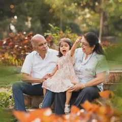 A little girl shares an animated story with her grandparents during an outdoor session. Capturing the bond across generations is one of my greatest joys.