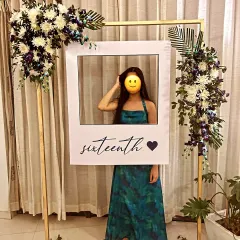 For a sweet sixteen, I created this chic and modern selfie booth. The simple gold frame was adorned with real flowers, and the custom polaroid-style cutout was a fun prop for the birthday girl and her friends.