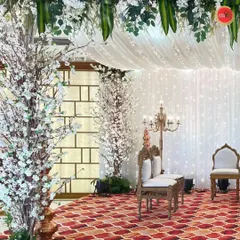 An ethereal all-white Vidhi Mandap design. We used white cherry blossom trees, a canopy of white florals, and a curtain of fairy lights to create a tranquil and elegant atmosphere for the ceremony.