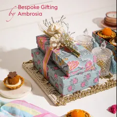 Bespoke gifting by Ambrosia, where we give a modern ode to traditions. This Rakhi hamper features our signature mithai tartlets and beautifully wrapped gift boxes, finished with dried flowers.