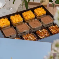 This is what happiness in a box looks like. Our assorted dessert cup box features a curated selection of our most popular trifles, including the fresh Mango & Cream Cheese, the classic Tiramisu, and the indulgent Chocolate & Caramel. It's a perfect centerpiece for a party or a luxurious gift.