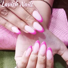 A vibrant and modern French manicure with bright pink tips on almond-shaped nails. This design offers a fun and colorful alternative to the traditional white tip.
