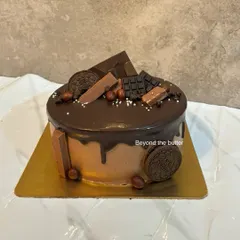 A chocolate lover's dream. This cake is loaded with chocolate drip, Oreo cookies, chocolate bars, and hazelnuts for a variety of textures and flavors.
