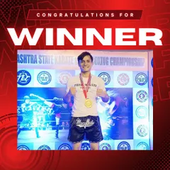 Another champion from our team, proudly displaying his gold medal after a victorious kickboxing tournament.
