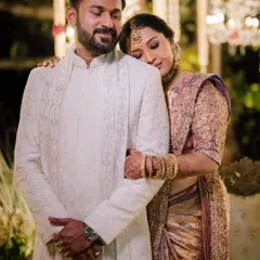 A moment of quiet comfort and love between the bride and groom amidst the grand celebrations of their wedding day.