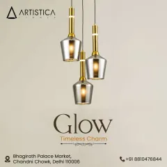 A beautiful cluster of three bell-shaped pendants with smoked glass and gold accents. This arrangement provides a timeless charm and a warm, layered light effect, perfect for hanging over a small table or in an entryway.