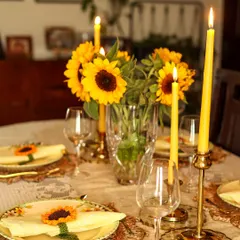 A festive table set for making memories. Here, my handmade sunflower napkin ties add a touch of sunshine to each place setting. I believe that gatherings are made special by these small, thoughtful details that bring warmth and personality to the table.