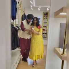 A mirror selfie showing off our coordinated Diwali outfits. I can help you and your partner find complementary looks for any festive event.