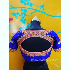 A classic design with a twist. This royal blue blouse has a beautiful eye-shaped back cutout, bordered with detailed red and gold hand embroidery for a striking look.