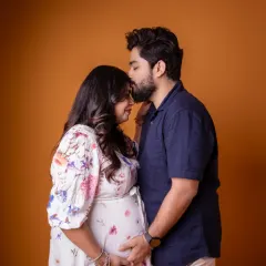 That look of love says it all. We captured this intimate moment between partners against a warm, simple studio backdrop, letting their connection be the focus.