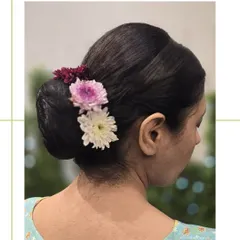 A side view of the floral bun, showing how the flowers are carefully placed to create a beautiful and balanced look from every angle.