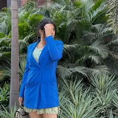 A closer look at the color combination of the blue blazer and green dress. Don't be afraid to mix bright, unexpected colors in your daily wardrobe.