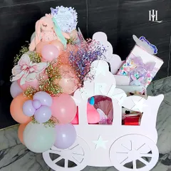 A baby girl's arrival is a magical event, and this charming pink chariot hamper is designed to match. It's filled with soft toys, balloons, and beautifully wrapped gifts for the little princess.