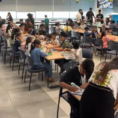 A wide shot of the packed hall at the MetLife corporate event. Our team successfully engaged hundreds of children simultaneously in structured, hands-on activities like LEGO building and 3D pen art.
