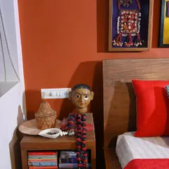 A bedside detail from the makeover, featuring a framed piece of Mochi Bharat embroidery and other collected objects. It's all about creating a home that reflects your personal story.