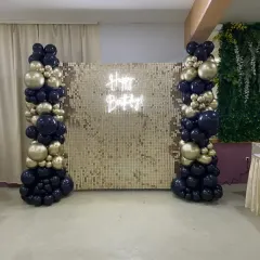 For this birthday party, the client wanted a glamorous photo wall. I used a gold sequin backdrop flanked by two balloon pillars in matching black and gold, with a "Happy Birthday" neon sign to light up the space.