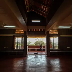 Symmetry brings a sense of balance and order to this space. The central axis draws the eye through the hall to the view beyond, while the exposed earth block walls and tiled floor create a feeling of harmony and connection to the natural surroundings.