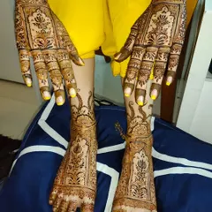 Another look at a complete bridal mehndi set. The intricate patterns on the hands are perfectly complemented by the detailed designs on the feet.