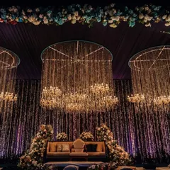 We create magical Sangeet nights with dramatic lighting and opulent decor. This stage features a cascade of crystal chandeliers against a dark, moody backdrop, perfect for an evening of music and celebration.