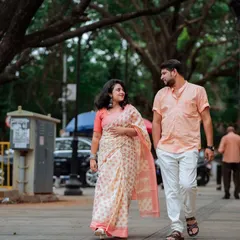 A candid shot of a couple walking and talking under the canopy of old trees. This image perfectly represents my style of capturing authentic interactions during a pre-wedding or couple photoshoot.
