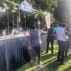 Guests gathering at our "Resto Bar" during a sunny outdoor wedding event. We love being the spot where everyone comes together to chat and grab a drink.
