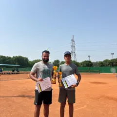 Celebrating the winner and finalist of the Delhi State Tennis Premier League for men. This image shows two of our top adult competitors on the clay court, holding their trophies and certificates after a hard-fought match.