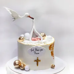 This gravity-defying Baptism cake features a hand-molded stork delivering a baby. It's a delicate and elegant design that showcases my ability to create structurally complex and meaningful edible art.