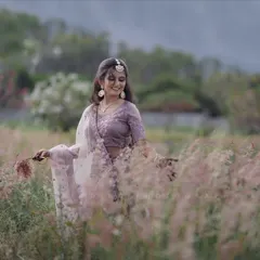 Capturing a joyful moment amidst nature. The makeup for this shoot was kept fresh and luminous to highlight her natural smile and ensure she looked radiant in the soft, diffused daylight of the outdoors.