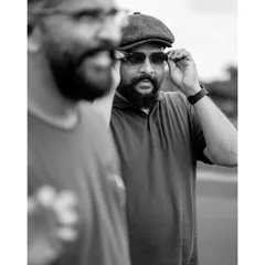 An artistic shot using reflection to create a double portrait. This black and white image has a cinematic quality, telling a story within a single frame.