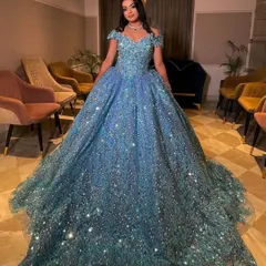 Here is one of my clients looking like a true princess in a fully embellished ice-blue ball gown. This rental gown is perfect for an engagement or reception, featuring off-shoulder sleeves and a voluminous skirt that sparkles with every movement.