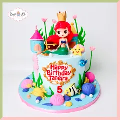 An under-the-sea adventure with The Little Mermaid. This cake features Princess Ariel, her castle, and friendly sea creatures like a crab and fish, all in a vibrant and colorful ocean setting.