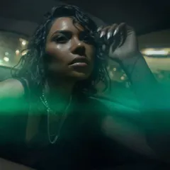A close-up portrait from the same night shoot, with neon green light flares adding a magical quality. This shows how we use the city's ambient light to create unique visual effects.