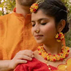 A serene portrait from a Haldi ceremony. The groom's gentle touch and the bride's peaceful expression create a moment of calm and connection amidst the vibrant celebration.