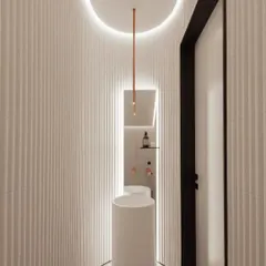 Even a small space like a powder room deserves a 'wow' moment. This toilet design uses curved, fluted walls, a sleek pedestal sink, and dramatic cove lighting to create a modern and sculptural look.