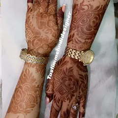 This photo shows two complementary modern designs, perfect for best friends. The patterns are bold and floral, with one hand featuring a lighter stain and the other a mature, dark stain.
