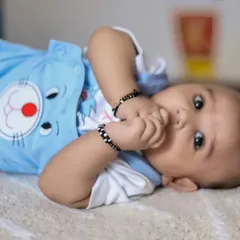 A curious baby looking right at the camera during an at-home photoshoot. We let babies be themselves to capture their emerging personalities.