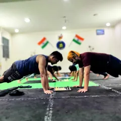 Two of my students holding a plank while playing chess. This is a perfect example of how we train the mind and body together, building focus and endurance simultaneously.