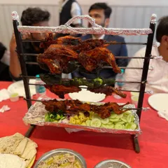 A "Groom's Table" special. This tiered stand presents a variety of grilled items, including tandoori quail and different types of kebabs.