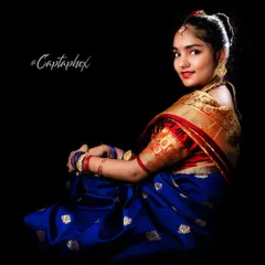 A classic three-quarter portrait in a beautiful silk saree. This pose highlights the detailed golden border of the saree and the traditional puff sleeves of the blouse, essential for ethnic wear lookbooks.