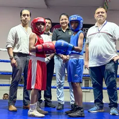 The face-off before a bout at the NMMC DSO Tournament held at our academy. Two young female boxers, fully geared up and ready to compete, showing true sportsmanship.