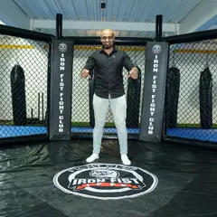 The voice of the Iron Fist Fighting Championship, "King James," standing center cage. Our octagon is built for professional-level action.