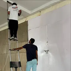 Our team at work on a commercial site. We use telescopic ladders to reach high ceilings and ensure cameras are placed for optimal coverage.