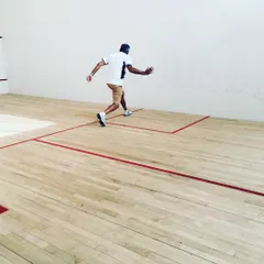 This shot captures the explosive movement away from the ball after a powerful stroke. We train our players to develop efficient recovery footwork to prepare instantly for the next shot.