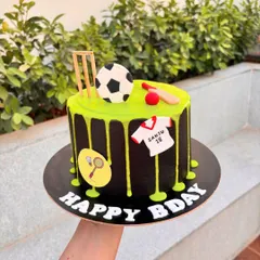 For the ultimate sports fan, this cake combines cricket, football, and badminton. The black cake with a neon green drip makes the design really stand out.