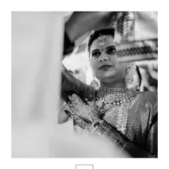 A striking black and white portrait of the bride, her gaze focused and intense, highlighting her timeless beauty.