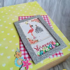 A detailed shot of the personalized shaker frame, filled with colorful sequins that move around.