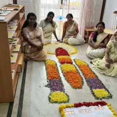 Our teachers sit beside a unique Onam pookalam shaped like the Chandrayaan rocket, blending tradition with national pride. Mera Bharat Mahan!
